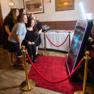 Guests using a mirror photo booth rental at a Bronx NY event with red carpet and gold stanchions