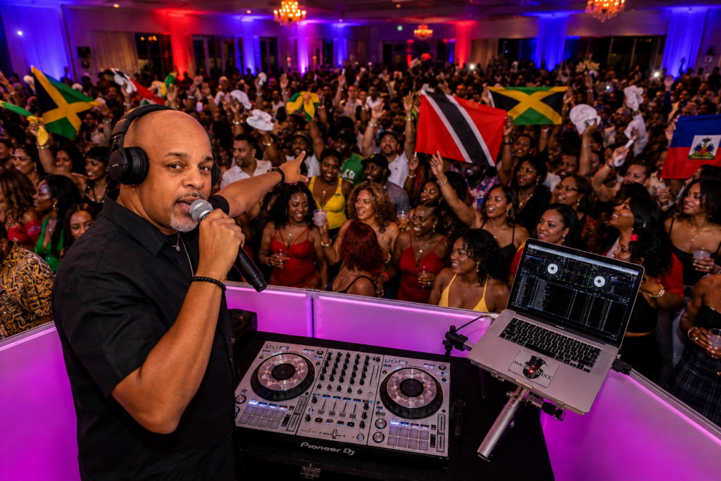 Caribbean DJ in Queens NY entertaining a packed dance floor with Soca, Dancehall, Reggae, and Afrobeats music
